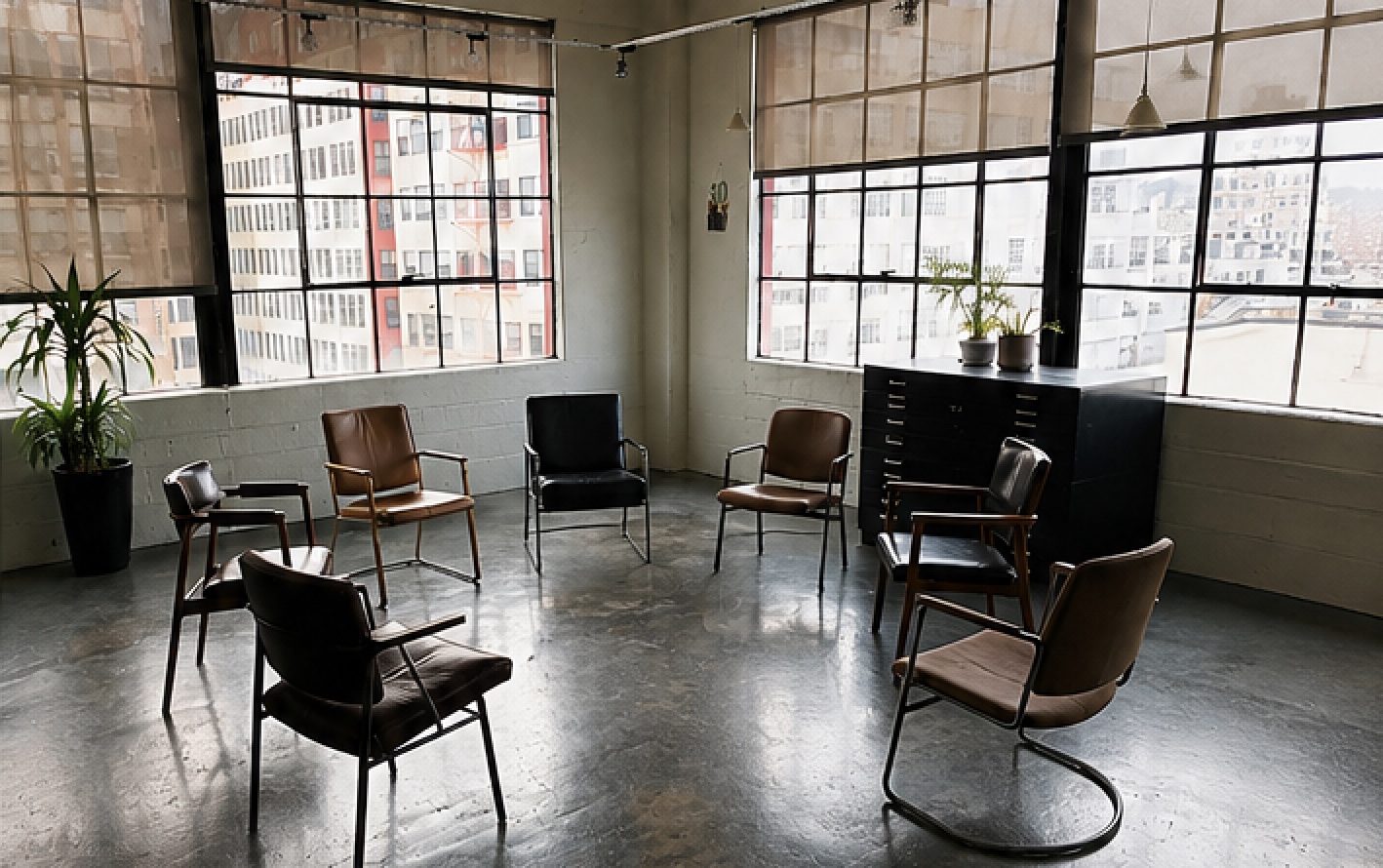Seven empty chairs arranged in a circle in the Downtown Los Angeles group room